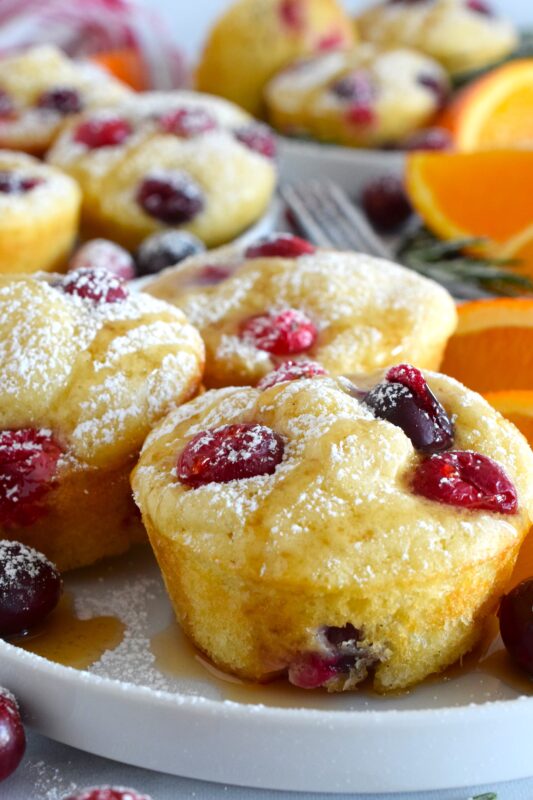 Say goodbye to standing over a griddle, watching and waiting for bubbles to form on your pancakes before flipping and watching and waiting some more. Cranberry Muffin Tin Pancakes are super easy to make, are completely customizable, and more importantly, are super fluffy and very flavourful! #pancakes #muffintin #holiday #breakfast #christmas #baked #cranberry #orange